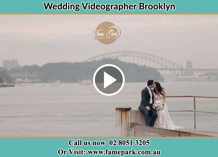 Bride and Groom kissed while sitting on near the shore Brooklyn NSW 2083