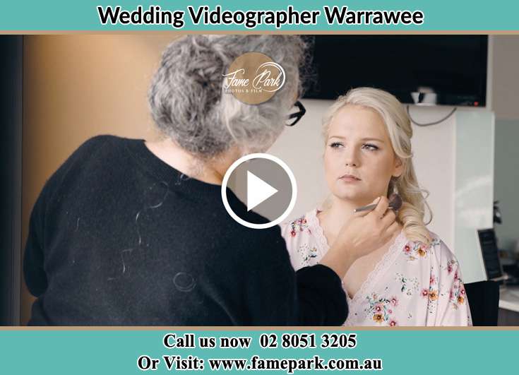 The makeup artist doing her job to the bride Warrawee NSW 2074